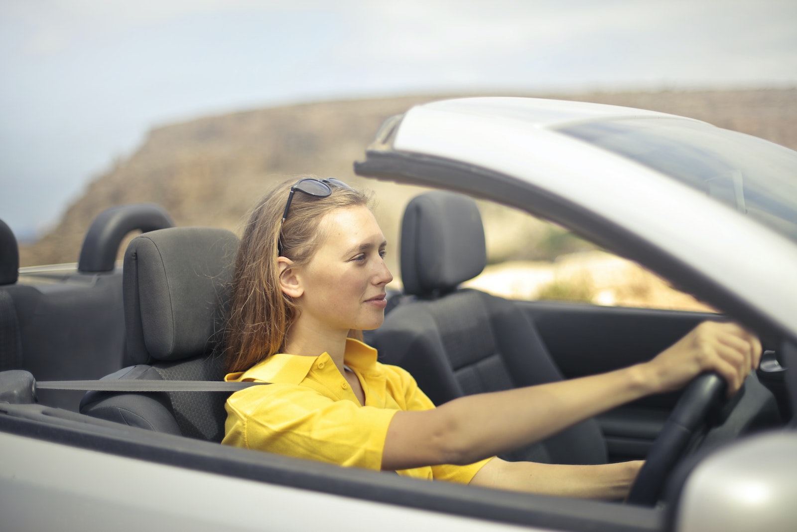 Woman in Yellow Shirt Driving a Silver Car, auto insurance